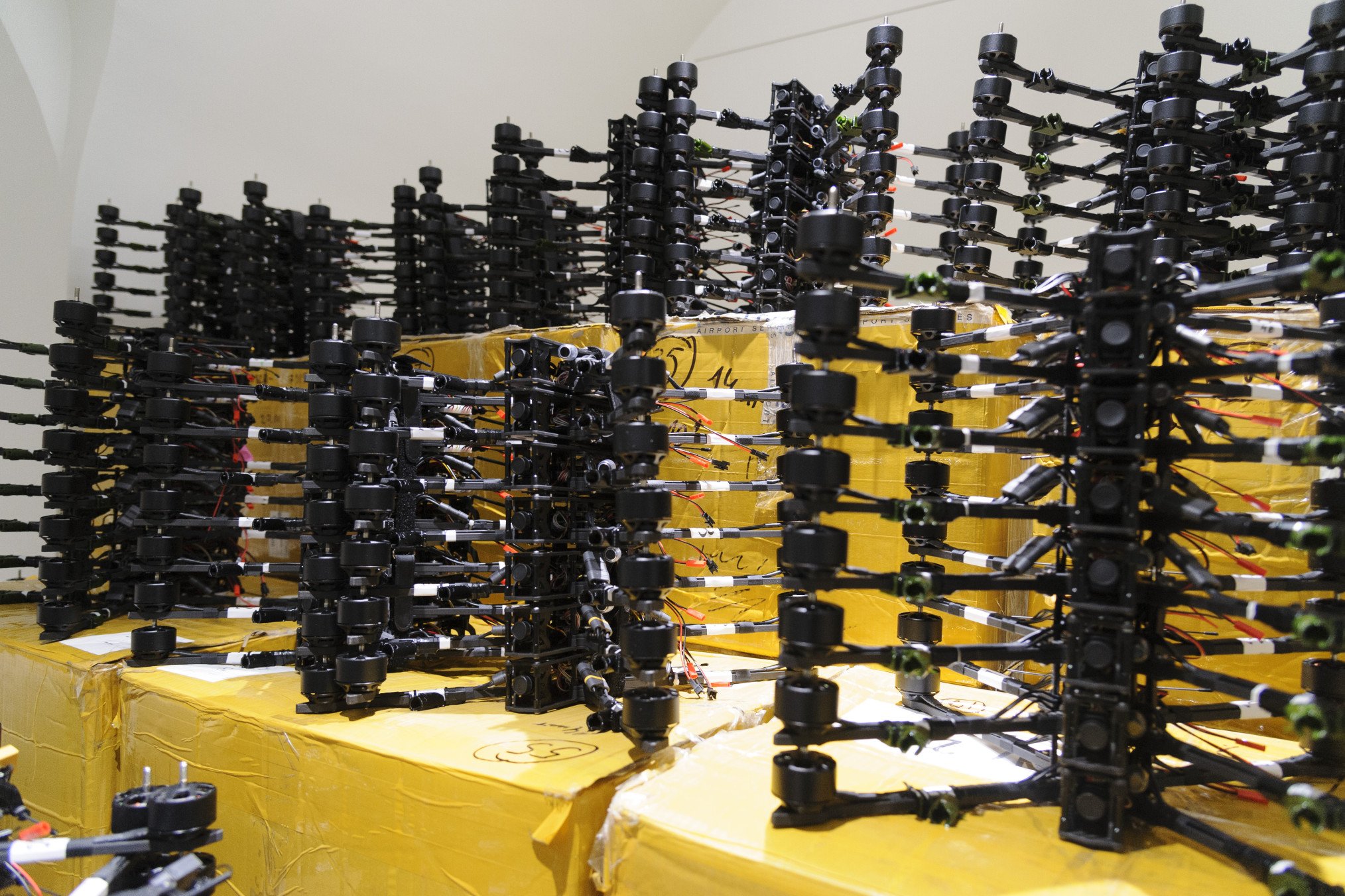 Drone motors and frames stacked on shipping boxes